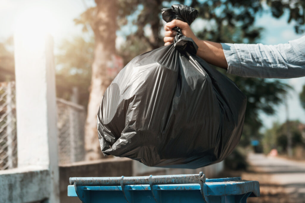 Woman,Hand,Holding,Garbage,Black,Bag,Put,In,To,Trash